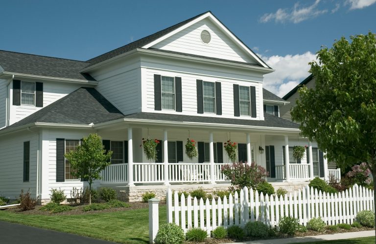 new home with an old country feel. large front porch and the white picket fence for the old time retro look. just one of many new house photos in my gallery.