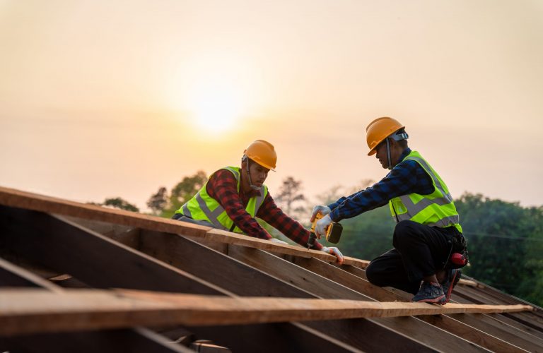 Two men installing a roof